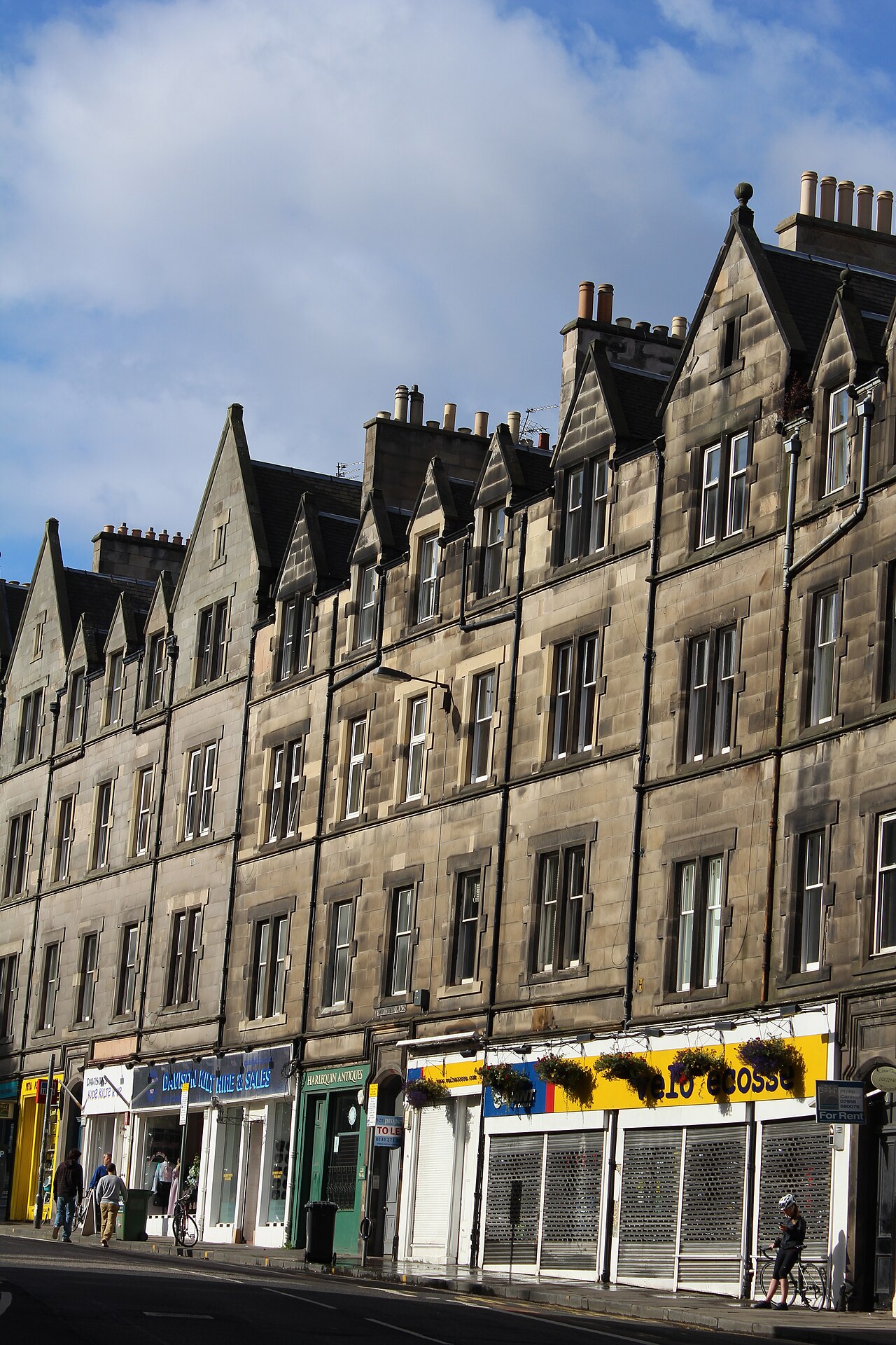 Sandstone tenements with ground-floor shops along Bruntsfield Place, Edinburgh.