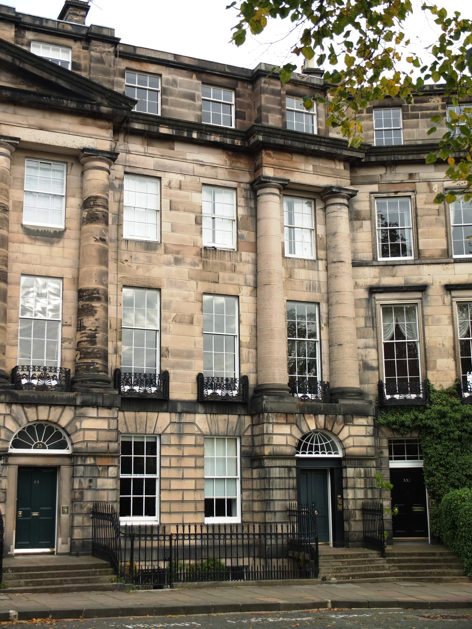 Georgian sandstone terrace at Moray Place, Edinburgh New Town, with columns, sash windows and a dark green door.